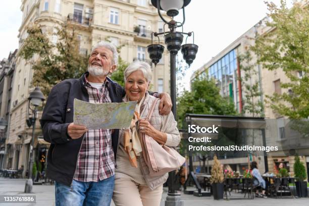Older Travelers Are Sightseeing The City During A Vacation Using A City Map Stock Photo - Download Image Now