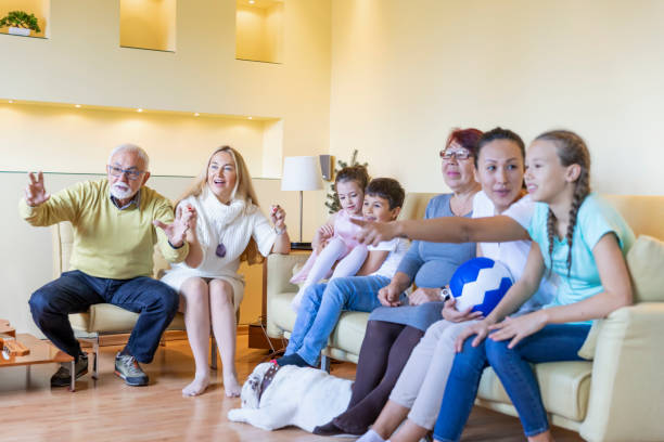 istock Cheerful Multi-Generation Family is Supporting National Soccer Team at Home. 1335763400