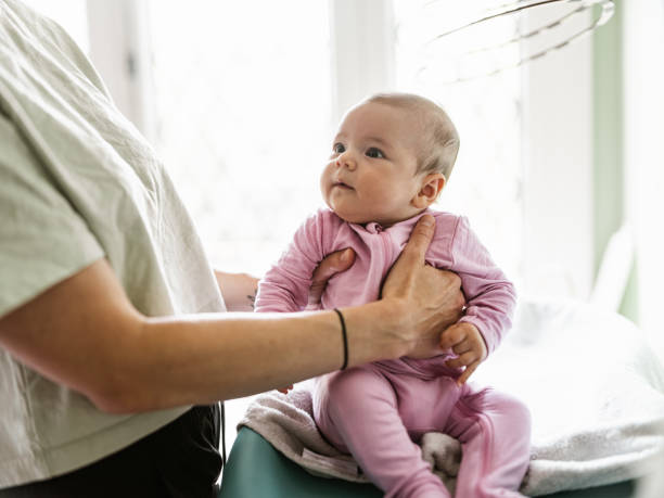 istock Young mother with baby at home 1335770722