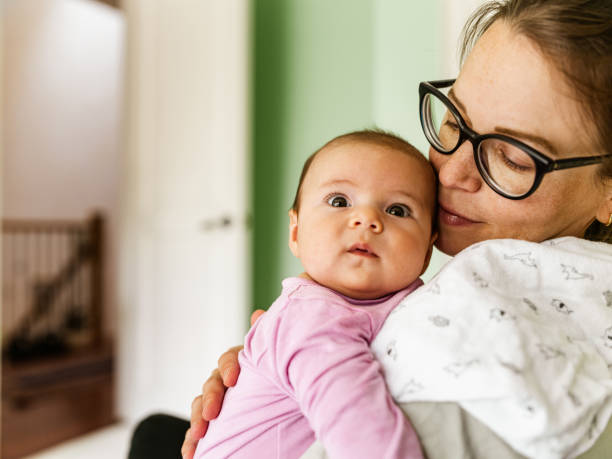 istock Young mother with baby at home 1335770746