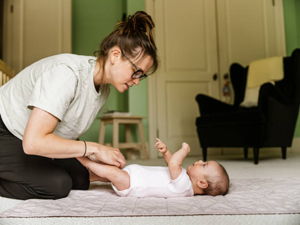 istock Young mother with baby at home 1335770749