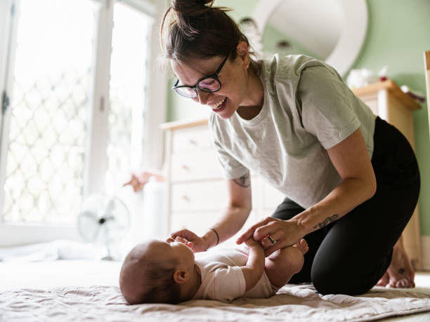 istock Young mother with baby at home 1335770752