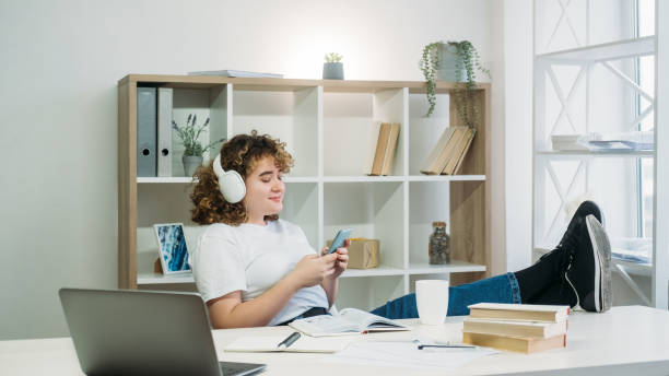 istock lazy student homework break woman phone texting 1335774532