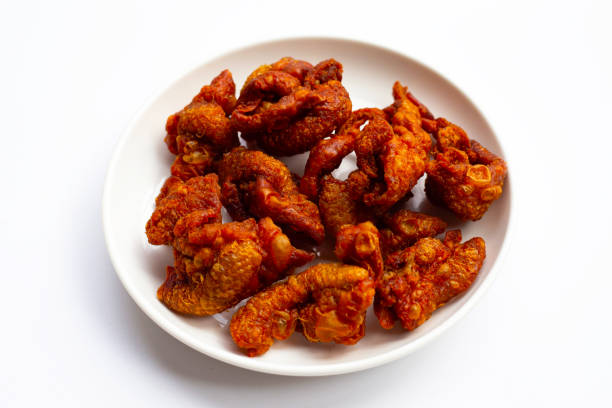 istock Chispy fried chicken skin in white plate on white background. 1335780895