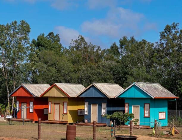 Tiny Homes A row of colorful tiny houses in a rural area, each with their own front door and small porch deck tiny house stock pictures, royalty-free photos & images