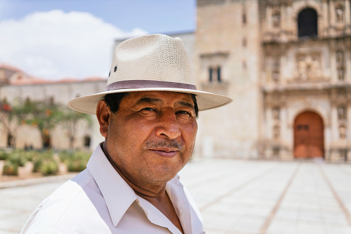 adult latino with hat on a sunny day