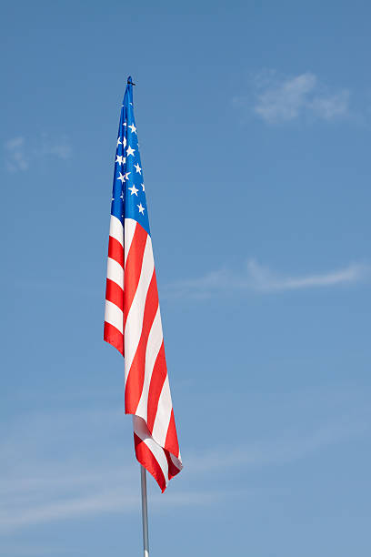 istock American Flag Against a Blue Sky, Vivid Color Image 133579679