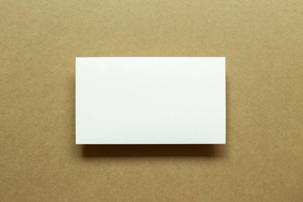 istock White blank memo paper on brown background. top view, copy space 1335800525