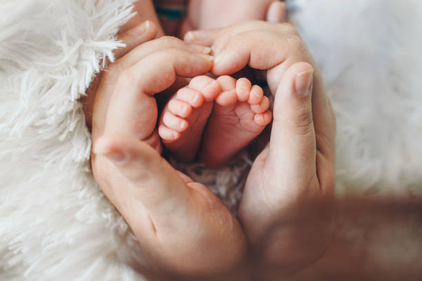 istock baby feet close up on white background 1335801412