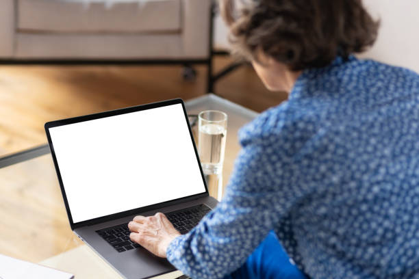 istock Views from back of aged business woman working while using laptop computer with blank screen 1335801476