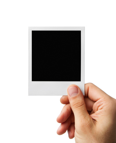 Male hand holding blank instant photo frame, clipping path included