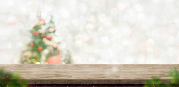 istock Merry Christmas wood table top at blur bokeh xmas tree decor with string light background,Winter banner backdrop for holiday greeting card 1335802136