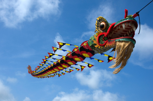 Dragon kite flying in the blue sky.