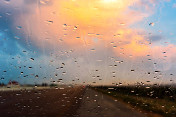 istock Raindrops on the windshield of a car 1335808472