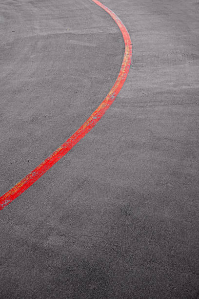 red curved line on asphalt stock photo