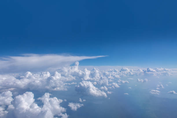 istock Beautiful cumulus fluffy white clouds on a blue sky with bright sun. Perfect abstract sky background, wallpaper 1335809091