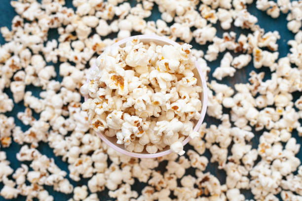 istock corn on wooden floor and popcorn in plate 1335810605