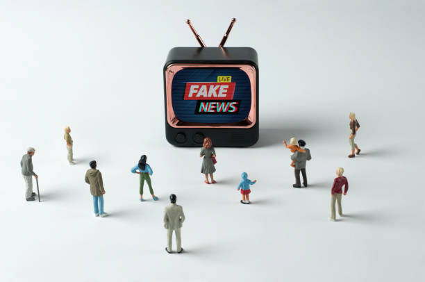 On TV: Fake news 1 People figurines watching "fake news" on TV. Post-truth concept fake news stock pictures, royalty-free photos & images