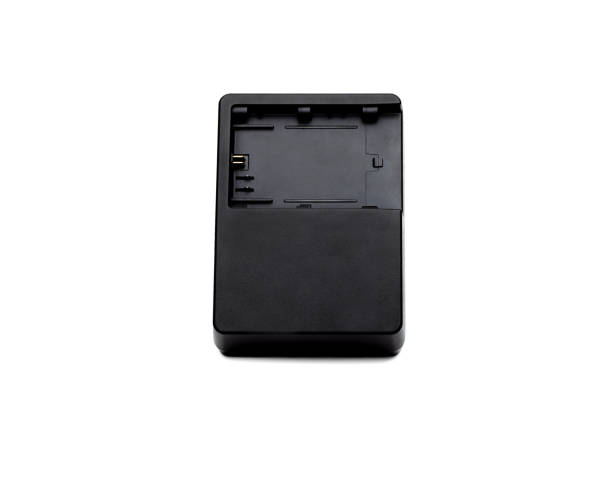istock Used black old camera charging adapter on isolated white background 1335814482