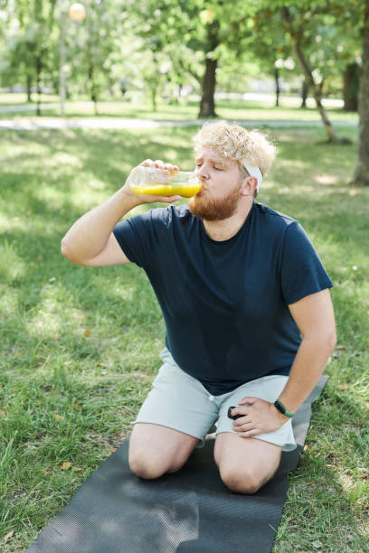 istock Man drinking fresh juice outdoors 1335814866