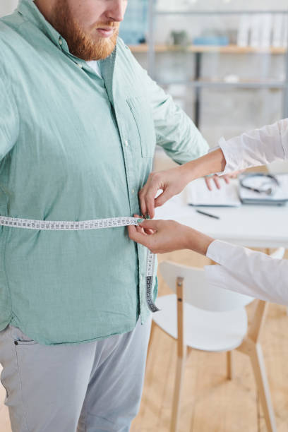 istock Man trying to lose his weight 1335814913