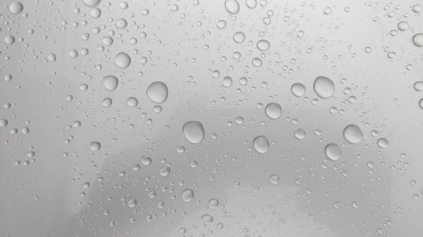 istock Close-up of water droplets on silver glass. 1335815980