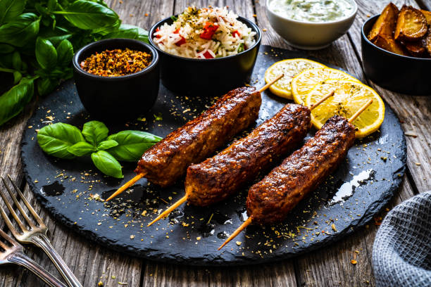 Cevapcici - Balkan shashlik with jasmine rice, tzatziki and lemon Cevapcici - Balkan shashlik with jasmine rice, tzatziki and lemon shish kebab stock pictures, royalty-free photos & images