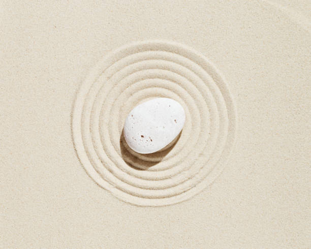 istock Zen garden meditation sandy background  White stone and lines on sand 1335824084