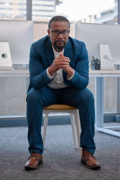 istock Shot of a young man sitting in a modern office 1335825587