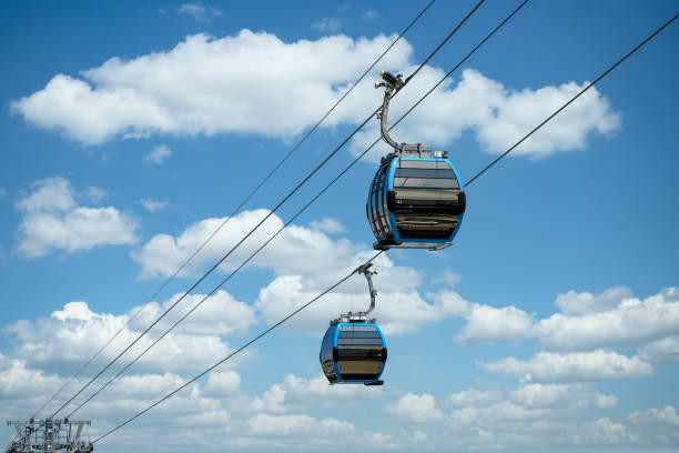 istock Cable car cabins against amazing sky and clouds. Cableway, green transportation. 1335827788