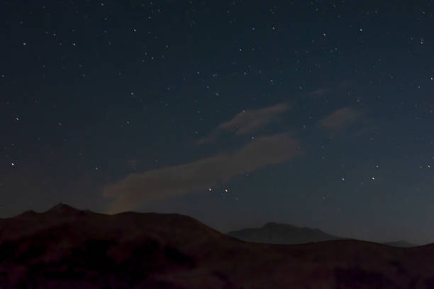 istock Night landscape. Starry sky and mountain peaks 1335830841