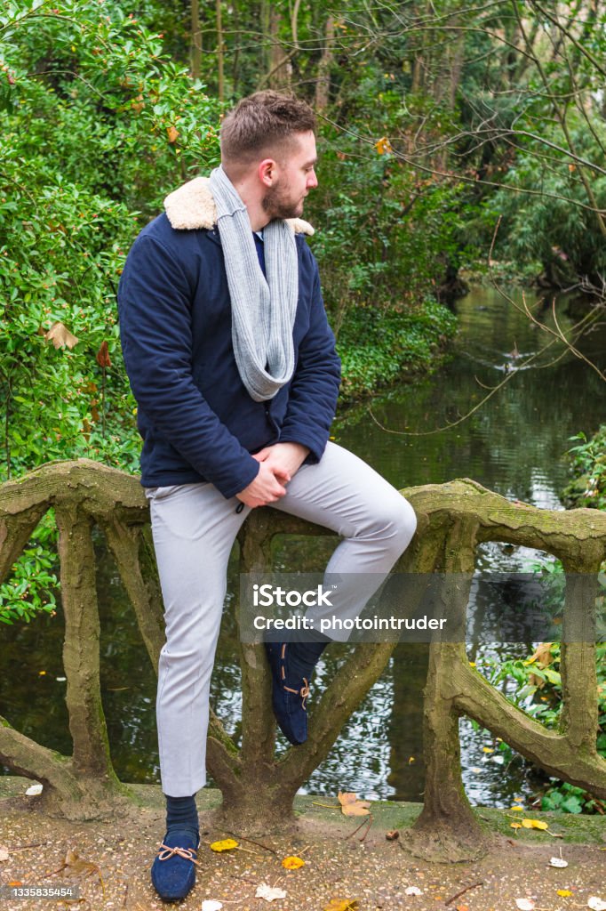 Stone Railing Sitting Young Man Sitting On Bridge With Stone Railing Stock Photo - Download ...