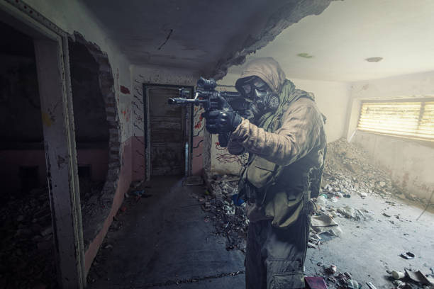 istock man in gas mask wandering through abandoned settlement. 1335835457