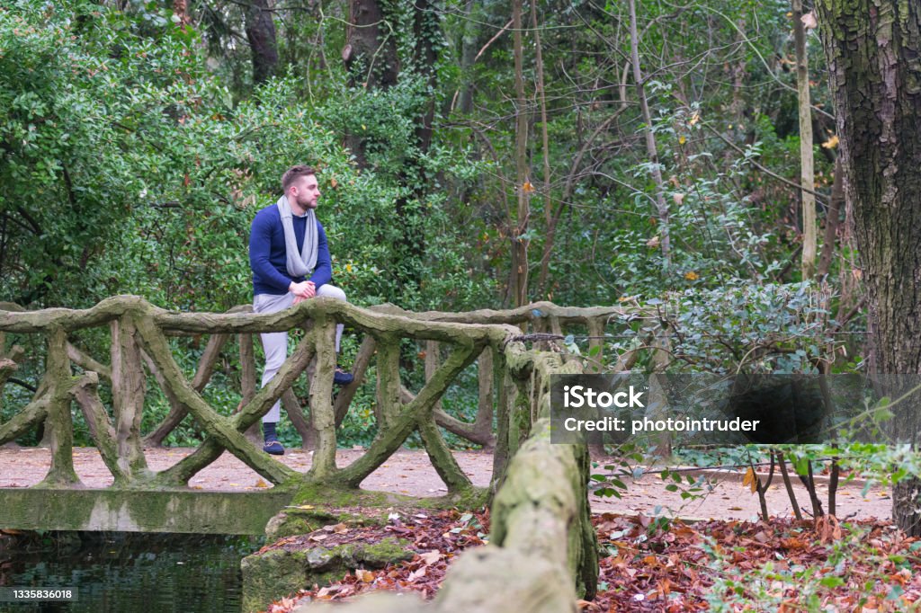 Stone Railing Sitting Young Man Sitting On Bridge With Stone Railing Stock Photo - Download ...