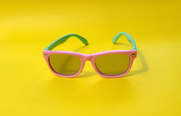 istock Sunglasses, Two-tone glasses, with a purple front frame and a turquoise stem on a yellow background. Radiation shielding glasses. 1335836788