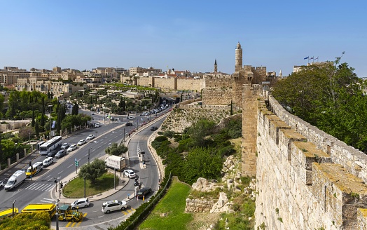 Jerusalem, Israel, May 1, 2019: View of the western part of the Old City wall with the Tower of David (right) on a sunny spring day.