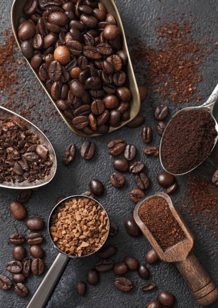 istock Ground and bean coffee and freeze dried instant coffee granules in various spoons and scoops on black background. 1335838538