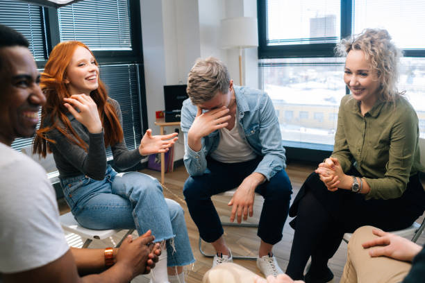 istock Group of cheerful young activity diverse multiethnic colleagues laughing during brainstorming near window. 1335840005