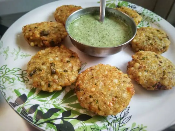 Sabudana or Sago Vada is a traditional Indian fried snack. Served with spicy green or peanut chutney.  Indian food.