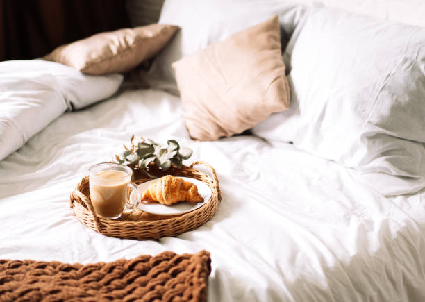 istock Breakfast in bed with croissant and coffee on tray 1335844568