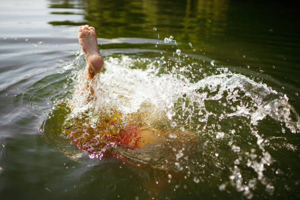 istock Young boy swimming in the lake 1335850408