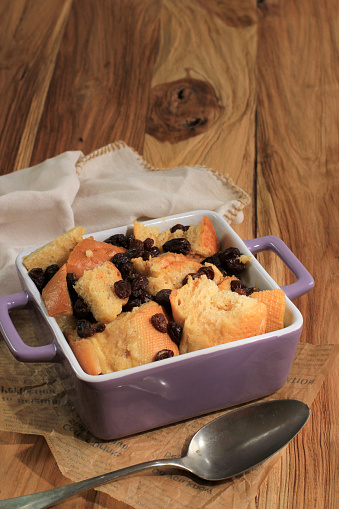 Close Up Cinnamon Bread and Butter Pudding with Raisins in Clear Baking Dish, Copy Space for Text
