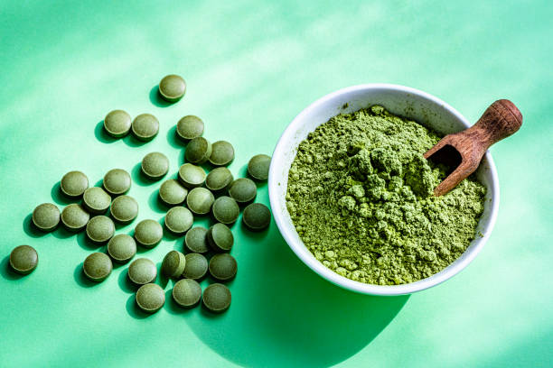 istock Moringa oleifera pills and powder on green background 1335854647