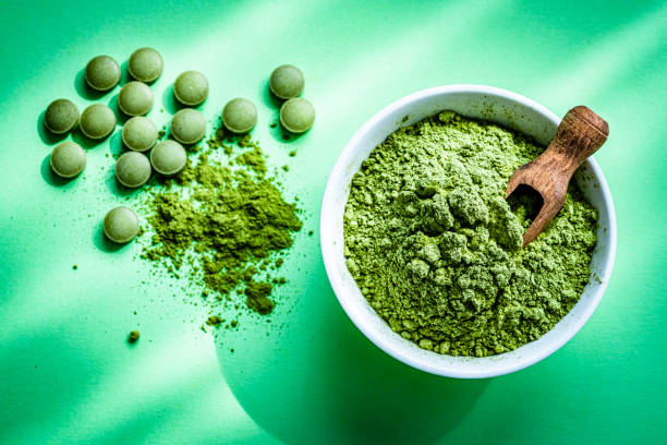 istock Moringa oleifera pills and powder on green background 1335854885
