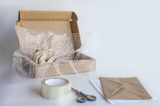 istock bubble pack, box, tape, scissors, paper envelope. Product packaging concept. 1335855637