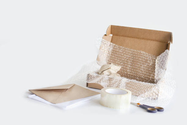 istock Tape, box, bubble pack, scissors, paper envelope. Product packaging concept. 1335855639