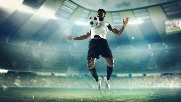 istock Football or soccer player at stadium - motion, action, activity concept 1335857719