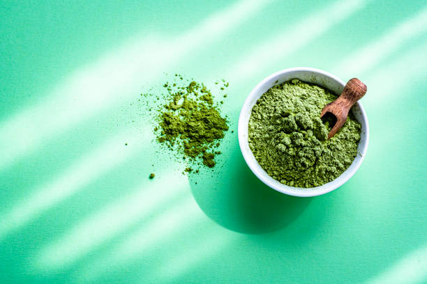 istock Moringa oleifera powder on green background. Copy space 1335858113