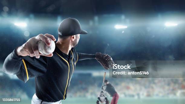 Professional Baseball Player In Motion Action During Match At Stadium Over Blue Evening Sky With Spotlights Concept Of Sport Show Competition Stock Photo - Download Image Now