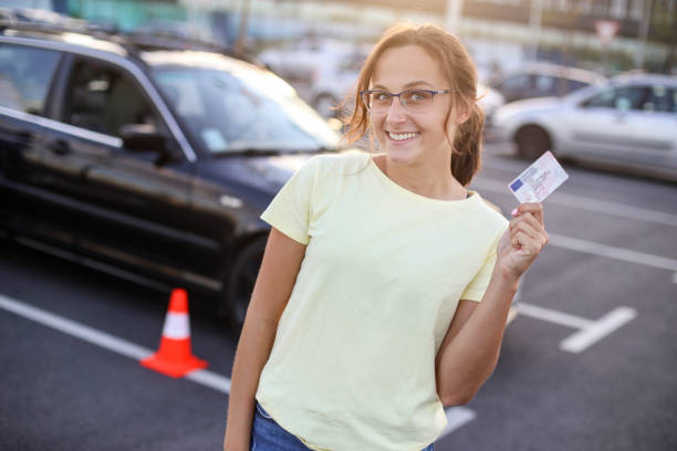 I got my driver's license Young woman learning how to drive a car. About 20 years old, Caucasian female. driving licence stock pictures, royalty-free photos & images